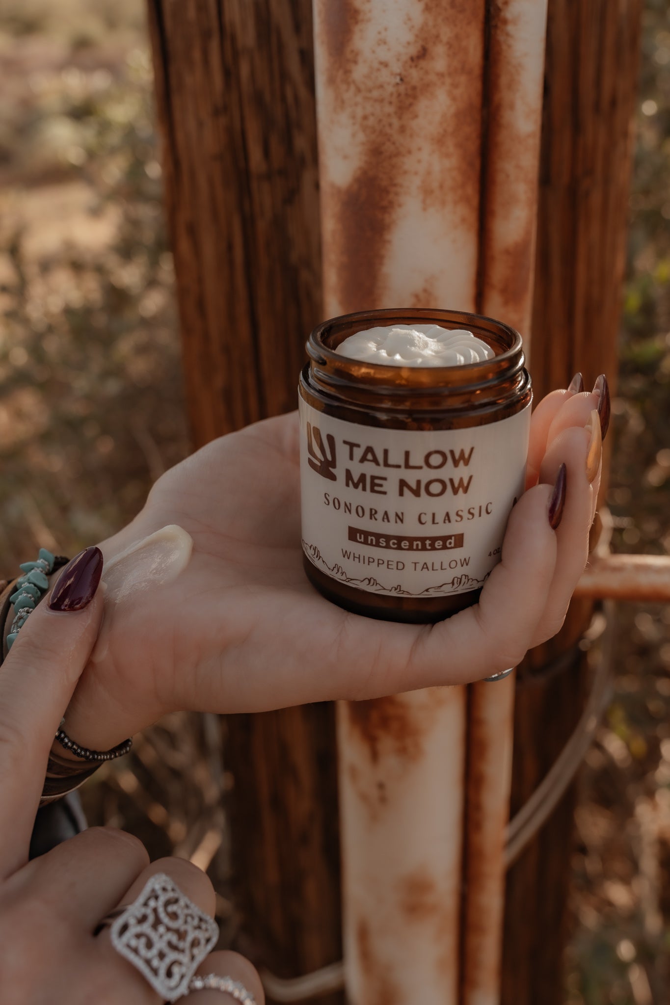 Citrus whipped tallow in amber jars surrounded by dried orange slices